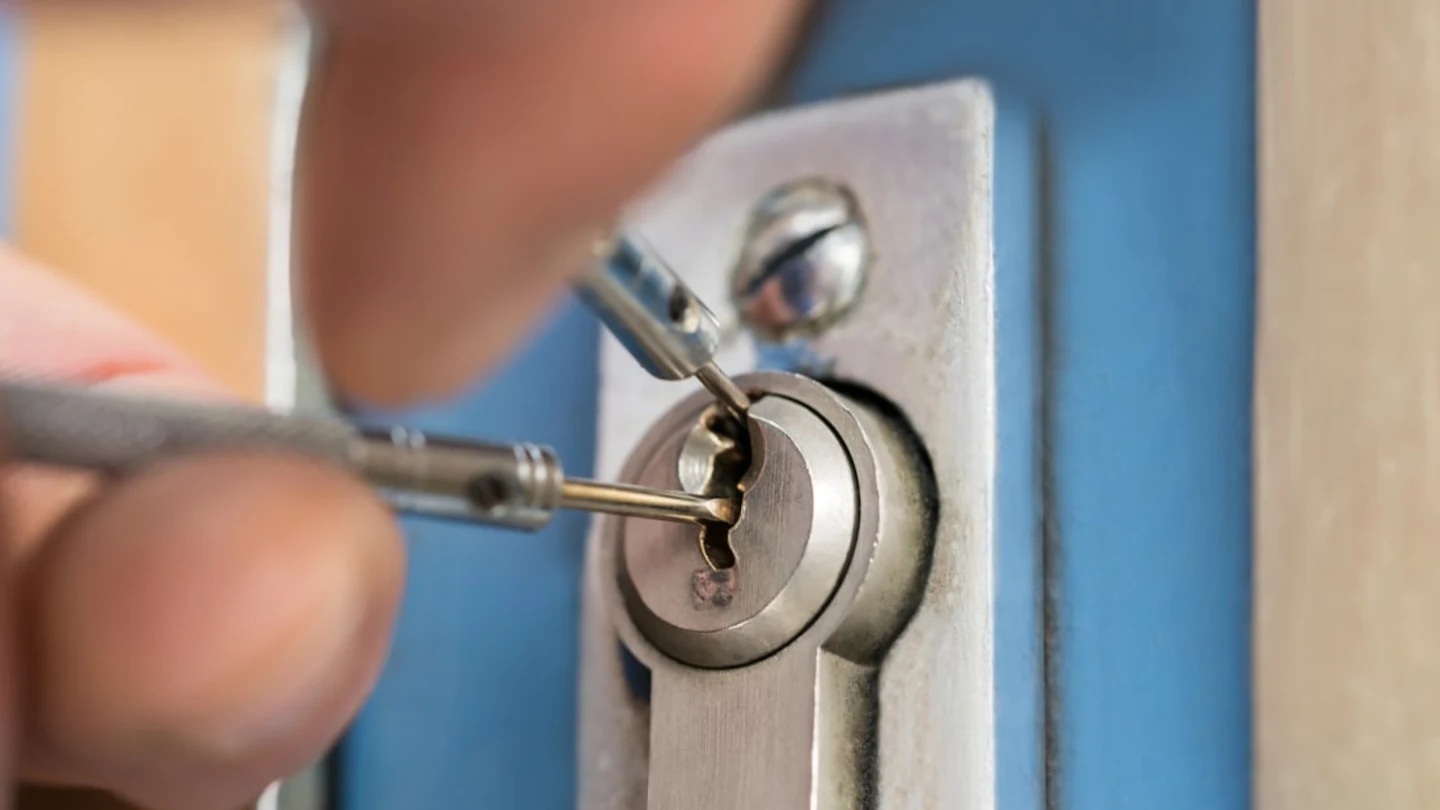 Emergency locksmith picking door lock mechanism in North West London