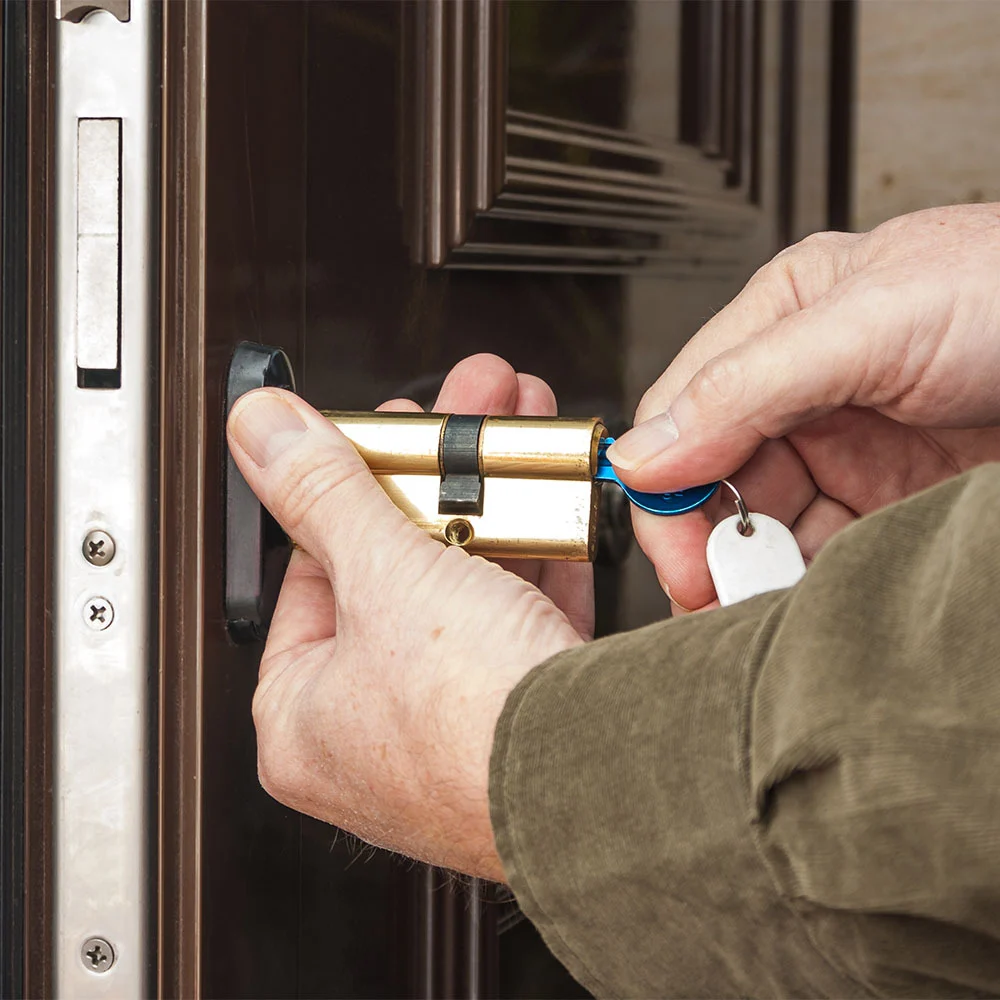 Locksmith fitting a high security anti-snap cylinder lock with key